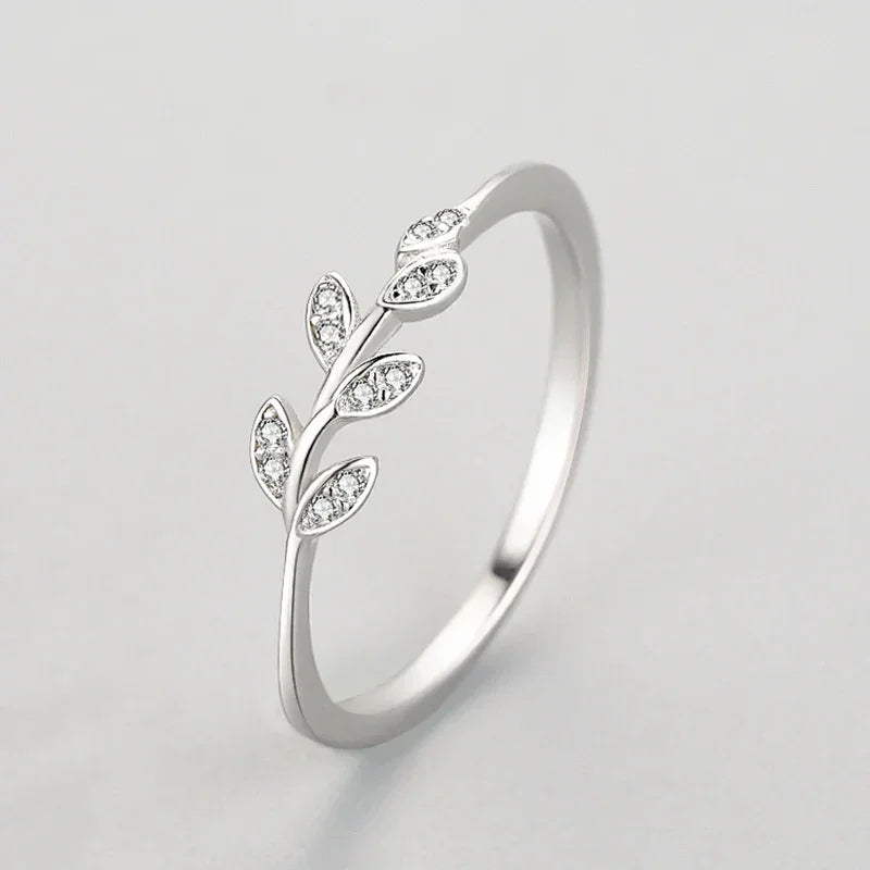 Sterling silver leaf ring with sparkling cubic zirconia accents on a white background