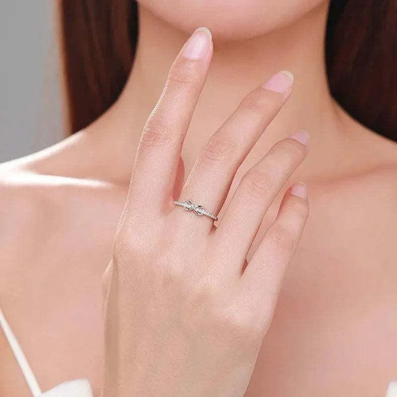 Woman wearing elegant 925 silver twisted band ring on finger, minimalist jewelry style