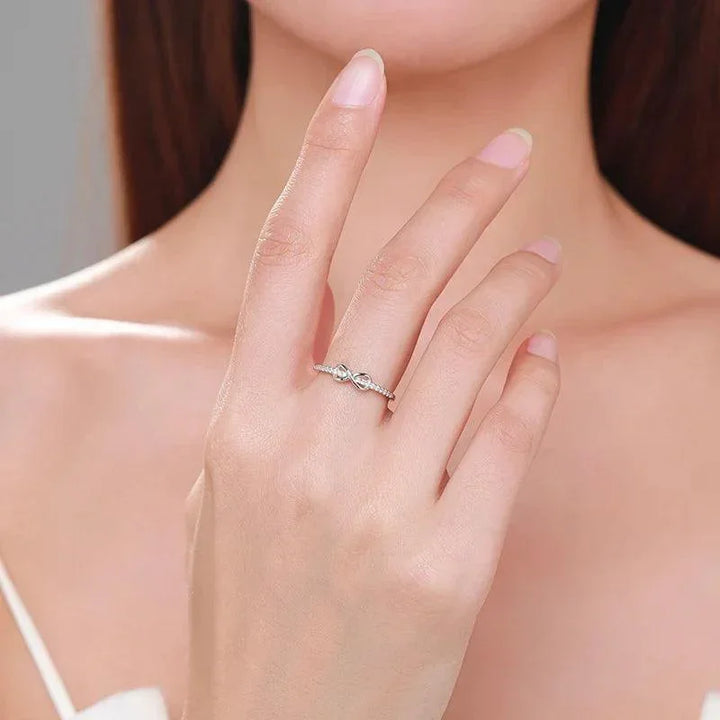 Woman wearing elegant 925 silver twisted band ring on finger, minimalist jewelry style