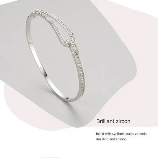 Crystal Maze Sterling Bracelet - TM & CO. JEWELS Silver bracelet with zirconia stones on a light gray background.
