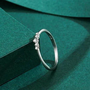 Silver ring with small diamonds on a green fabric background-TM & CO. JEWELS .
