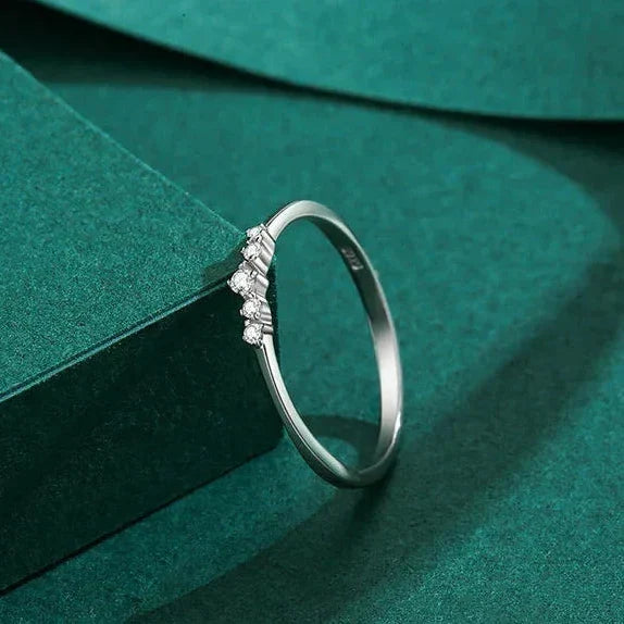 Silver ring with small diamonds on a green fabric background-TM & CO. JEWELS .