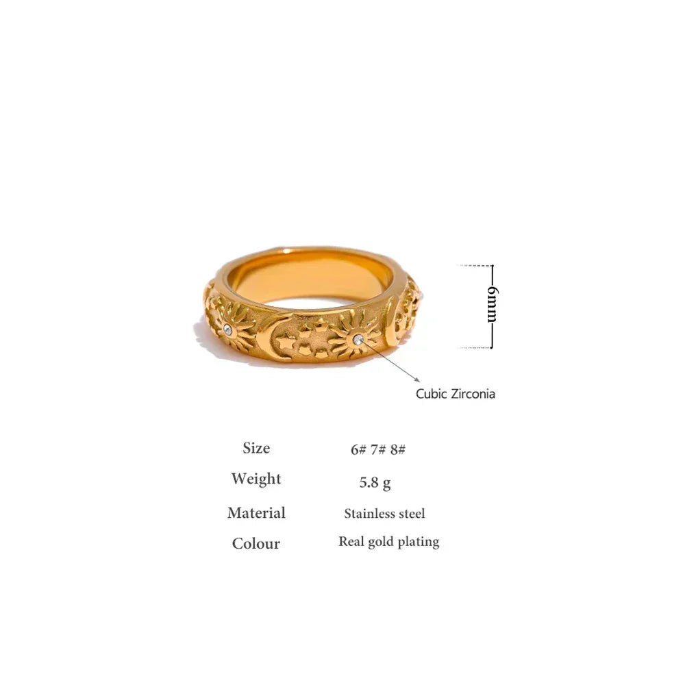Gold-plated stainless steel ring with floral engravings and cubic zirconia accents, 6mm wide.