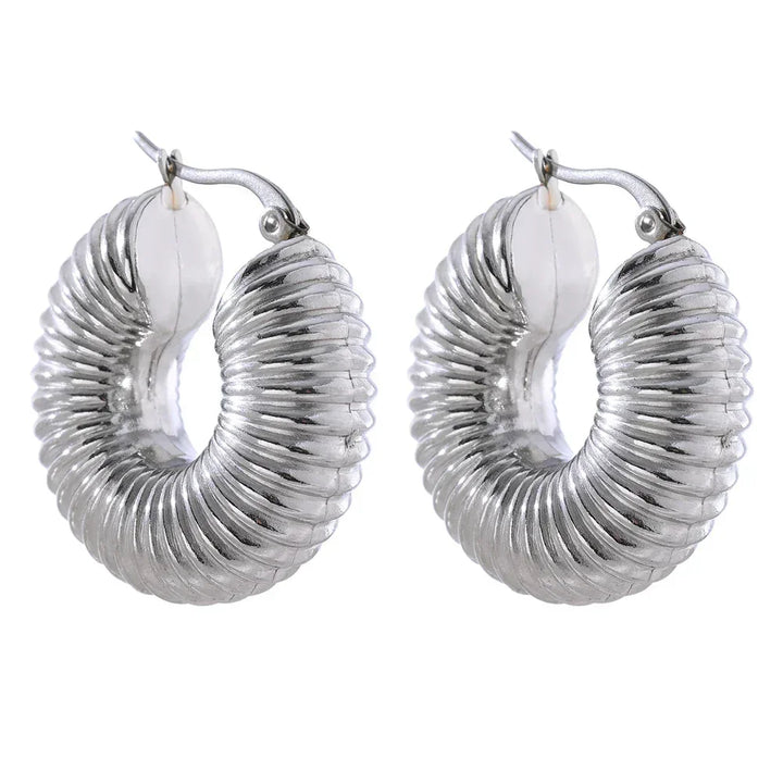 Ribbed chunky 925 silver hoop earrings with a bold curved design on white background