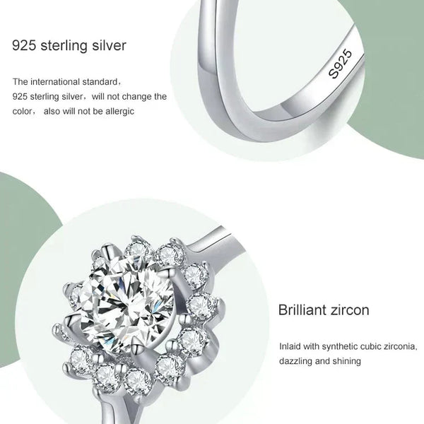 Silver ring with zirconia stones and '925 sterling silver' text on a light green background