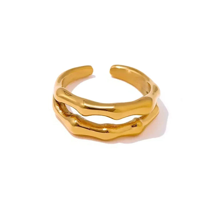 Gold ring with a wavy design on a white background