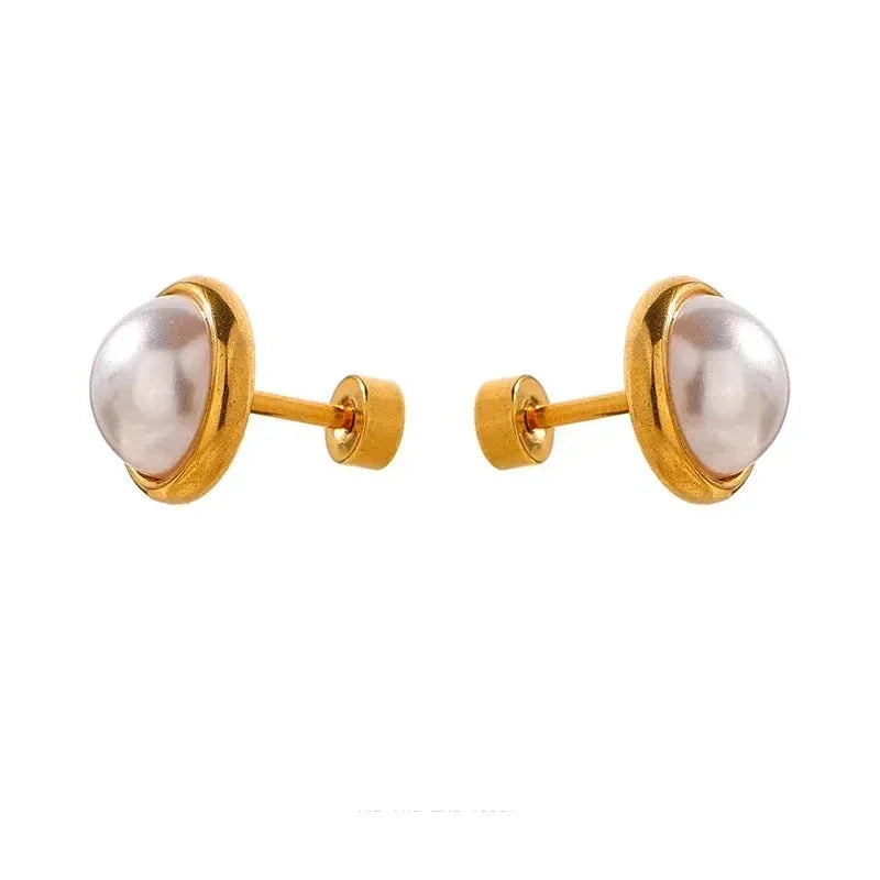Gold-plated pearl stud earrings on white background, elegant women's jewelry