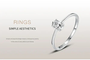 925 silver ring with single round-cut diamond, minimalist elegant jewelry on neutral background.