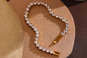 Crystal bracelet with gold clasp on a textured surface