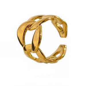 Gold ring with a braided design on a white background