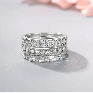 Silver ring with intricate design on a light gray background