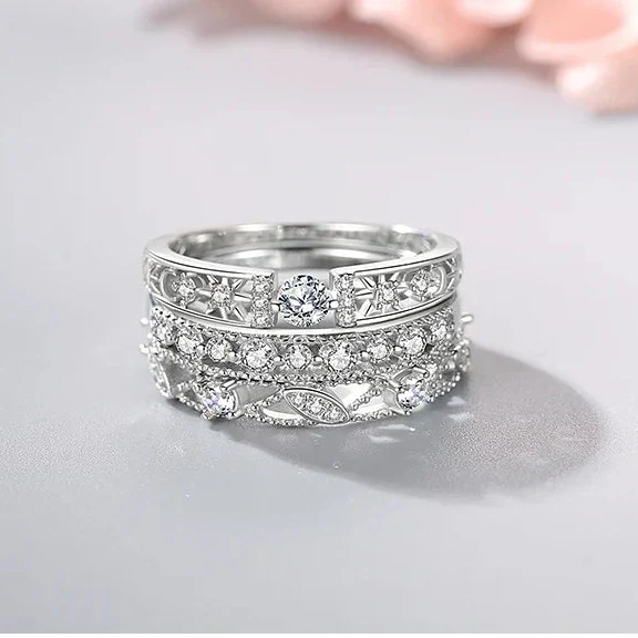 Silver ring with intricate design on a light gray background