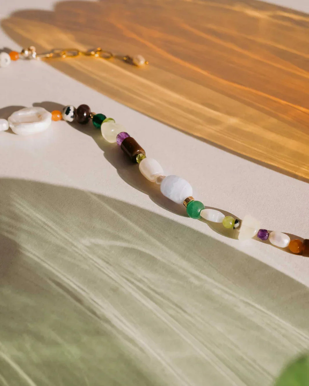 Necklace with multicolored beads on a wooden surface