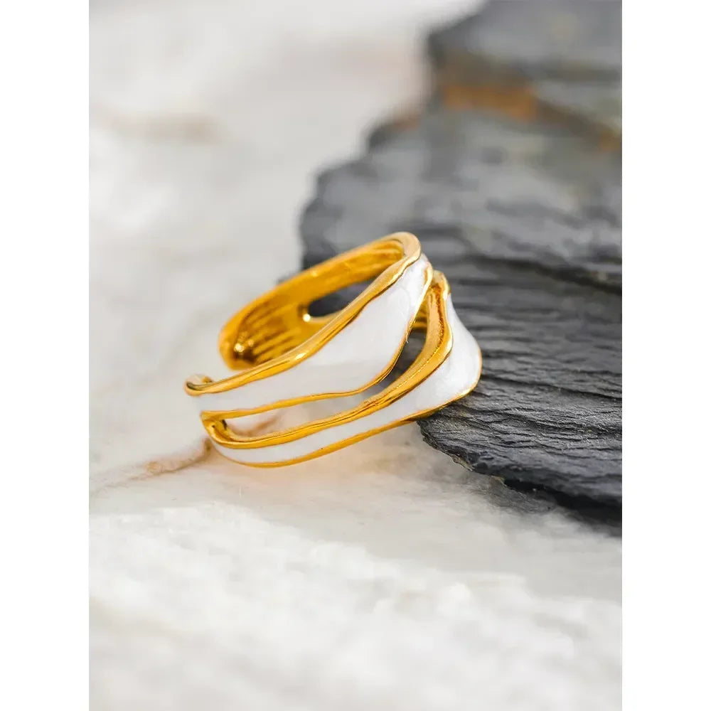 18K gold-plated adjustable ring with white enamel accents on a marble background