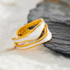 18K gold-plated adjustable ring with white enamel accents on a marble background