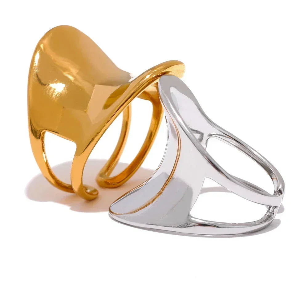 Modern open band rings in gold and silver, abstract sculptural design, on white background