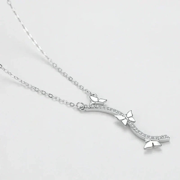 Wings of Nature Necklace - TM & Co. Jewels-Silver necklace with a bow-shaped pendant on a light gray background.