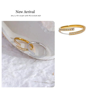 Gold and silver open rings with small crystals, minimalist jewelry on textured fabric