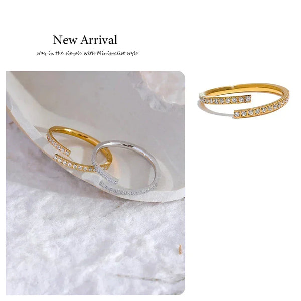 Gold and silver open rings with small crystals, minimalist jewelry on textured fabric