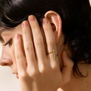 Woman wearing 18K gold-plated zigzag ring with crystals by her ear