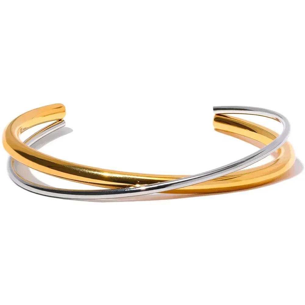 Gold and silver twisted open bangle bracelet on white background, elegant jewelry accessory