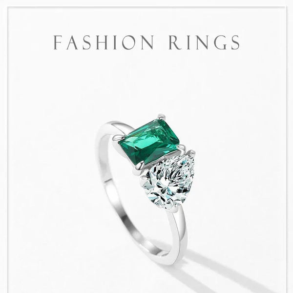 Silver ring with green gemstone on a white background