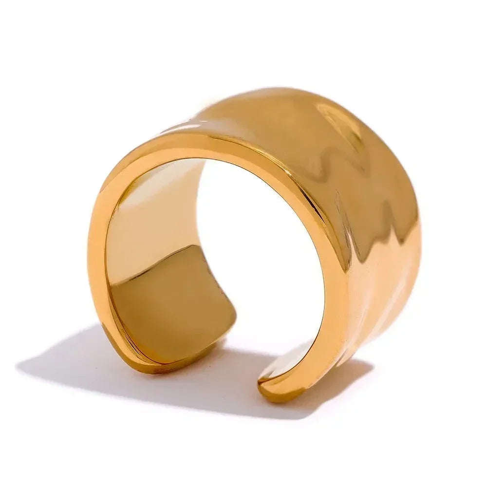 Wide 18K gold-plated open cuff ring with a smooth, polished finish on a white background