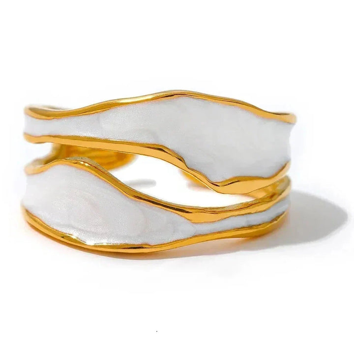Gold and white marbled cuff bracelet on a white background