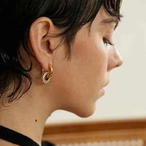 Gold-plated hoop earrings with crystal accents, styled on ear for everyday elegance