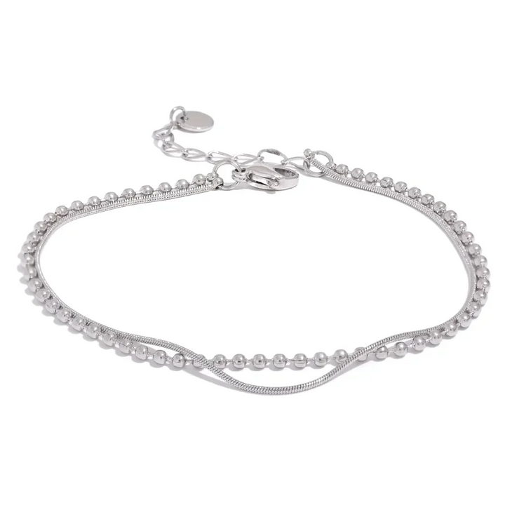 Sterling silver double chain bracelet with beaded detailing on white background.