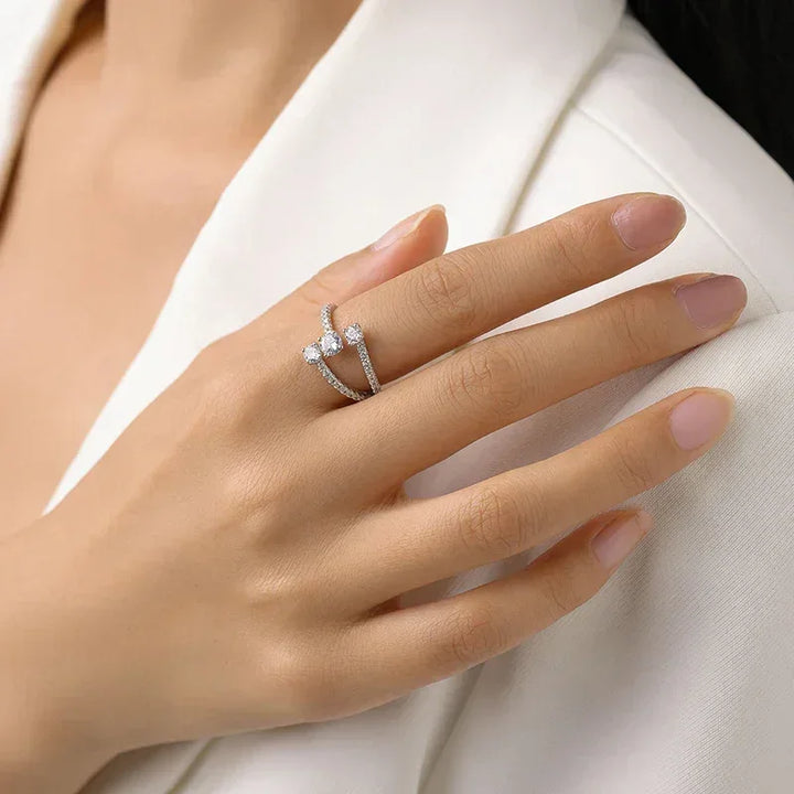 Elegant woman's hand wearing a modern 925 silver and cubic zirconia open ring