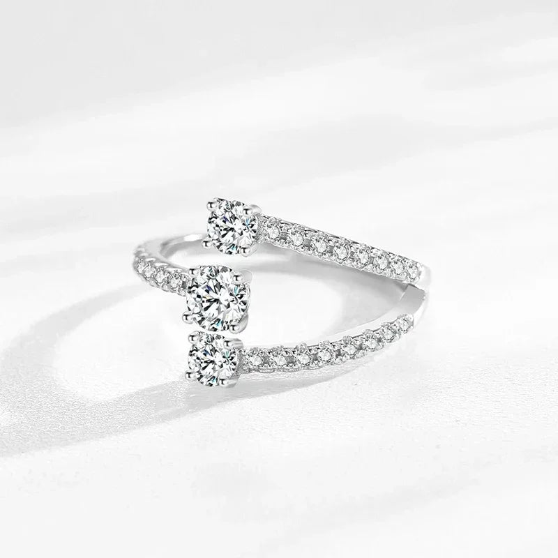 Sterling silver open ring with three round-cut cubic zirconia and pavé band accents