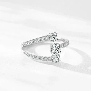Sterling silver open ring with three round-cut cubic zirconia and pavé band accents
