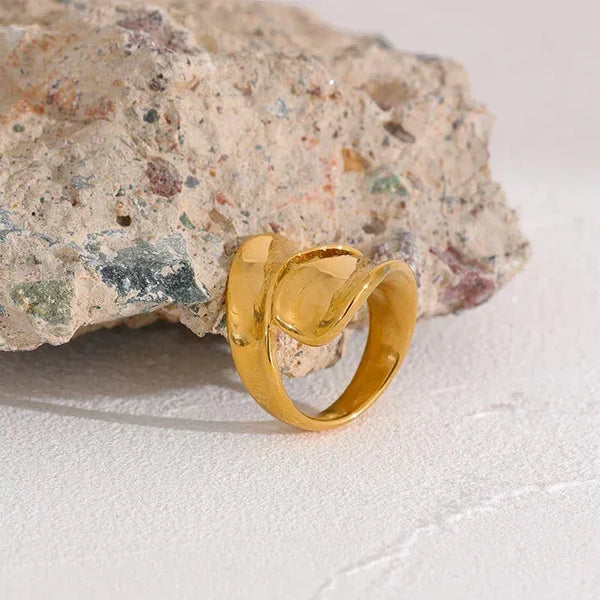 18K gold-plated twisted band ring on stone, elegant women's jewelry closeup
