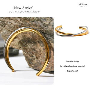 Gold and silver bracelet on a stone background with 'NEW++' branding.