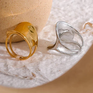 Modern wide band 18K gold-plated ring with unique open design on white background
