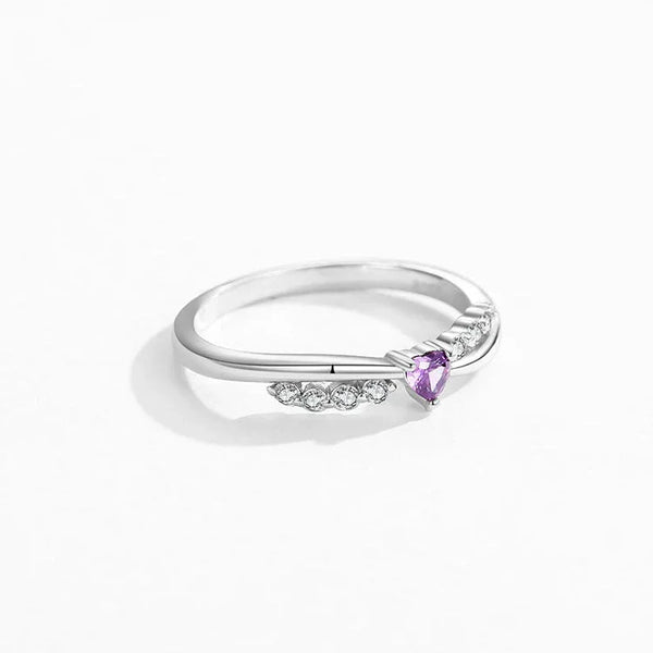 Silver ring with a purple gemstone on a white background