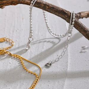 18K gold-plated and 925 silver beaded chain bracelets displayed on a branch