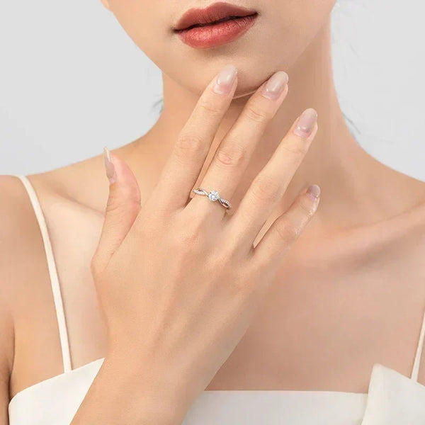 Woman wearing elegant silver ring with center stone, minimal jewelry, neutral background