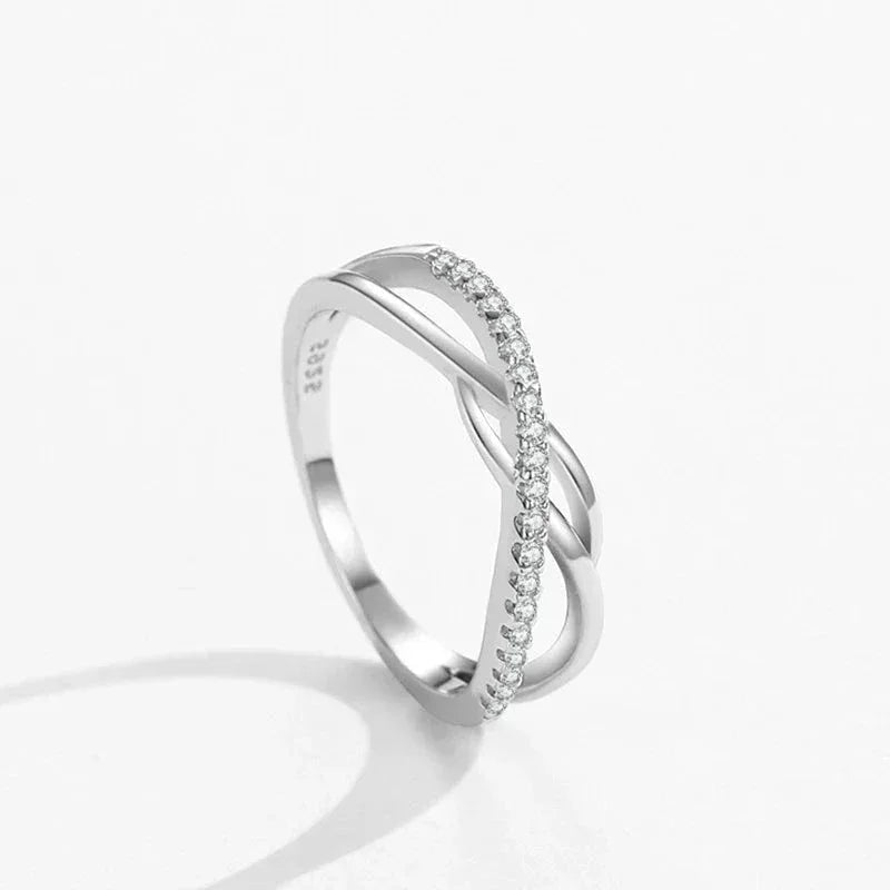 925 silver twisted infinity ring with cubic zirconia accents on white background