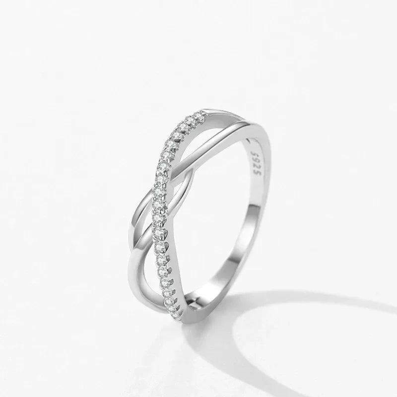 925 sterling silver infinity ring with sparkling cubic zirconia accents on white background
