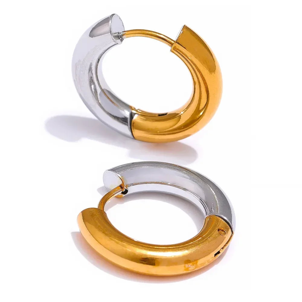 Pair of two-tone gold and silver chunky hoop earrings on a white background
