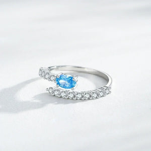 Silver ring with a blue gemstone on a white background