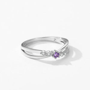 Silver ring with a purple gemstone on a white background