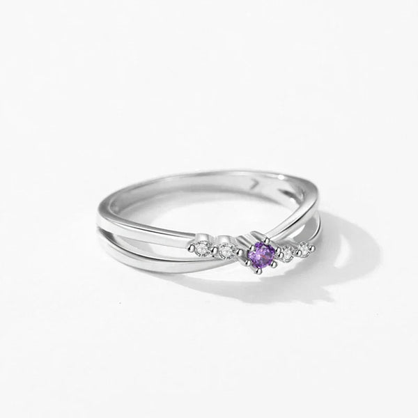 Silver ring with a purple gemstone on a white background