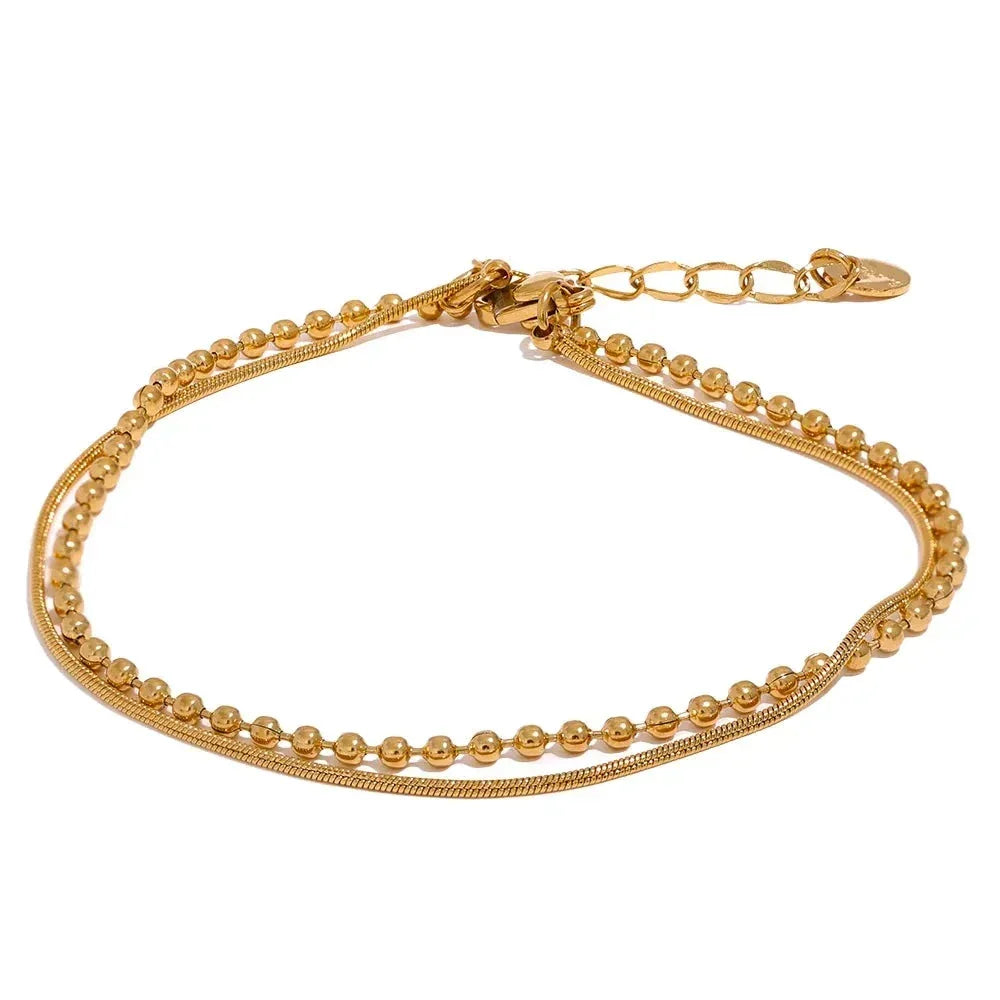 18K gold-plated double-layered bracelet with beaded and snake chain design on white background
