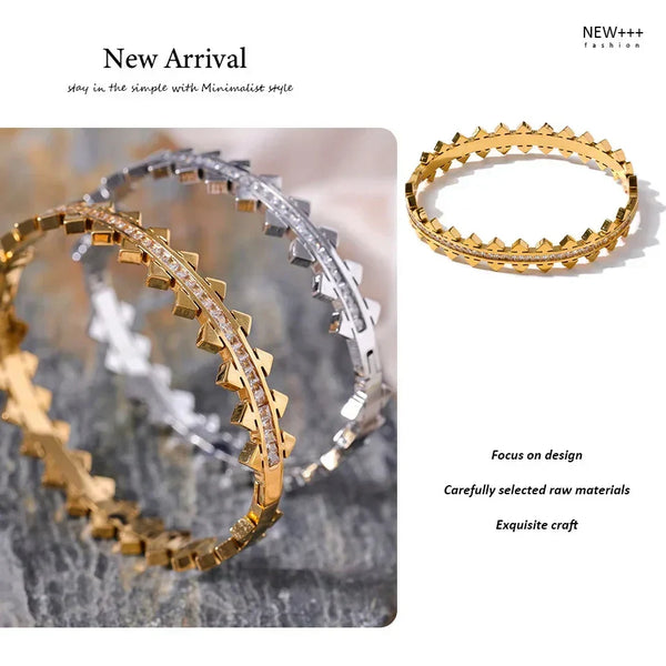 Two gold and silver bangles on a textured surface with 'NEW++' branding.