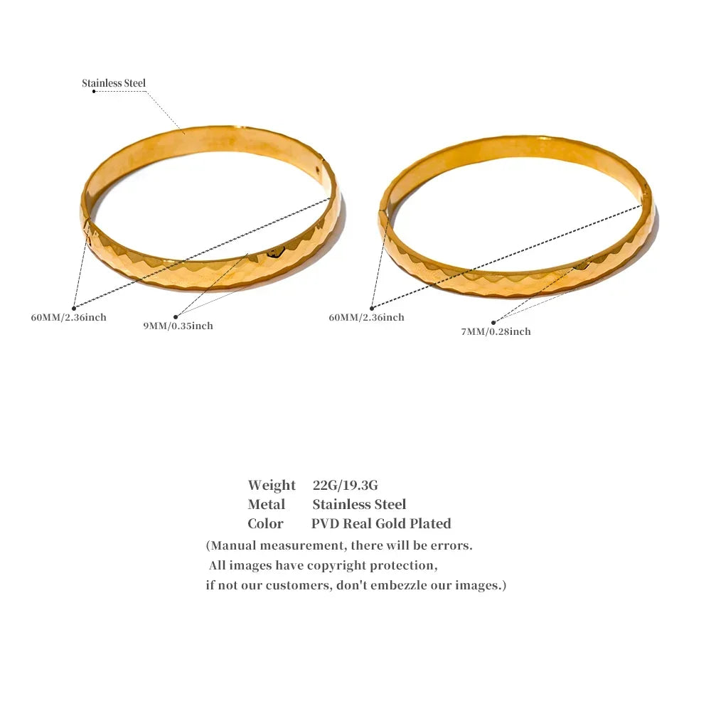 Two gold-plated stainless steel bangles with textured finish, 60mm diameter, 7mm and 9mm width.