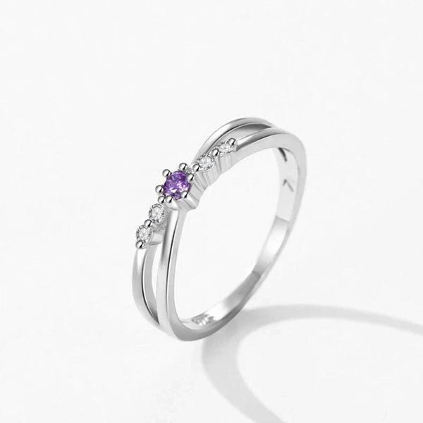 Silver ring with a purple gemstone on a white background