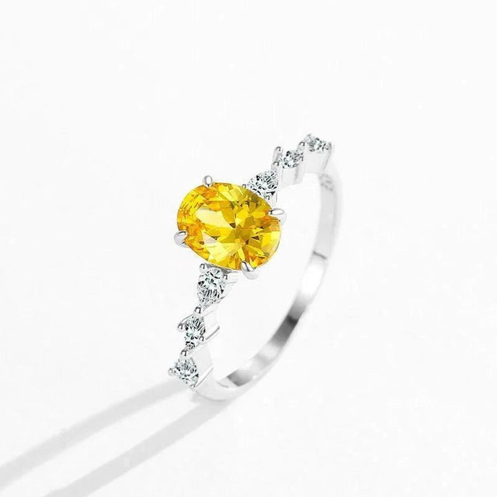Amber Luxe Engagement Ring - TM & CO. JEWELS - Ring with a yellow gemstone and diamond accents on a white background.